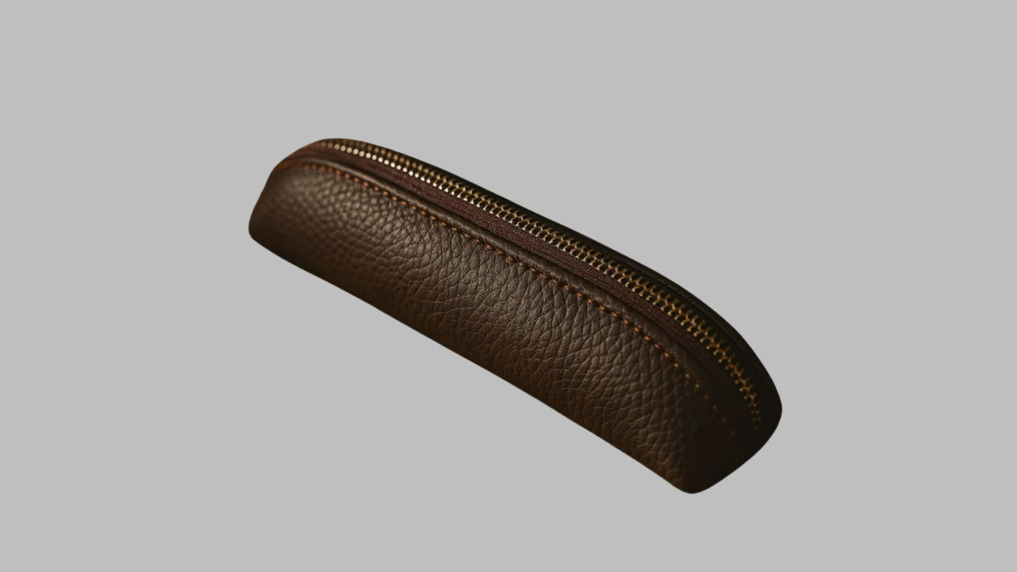 Brown leather pencil case with a zipper on a white background