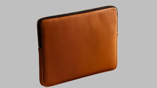 Brown leather laptop sleeve on a white background