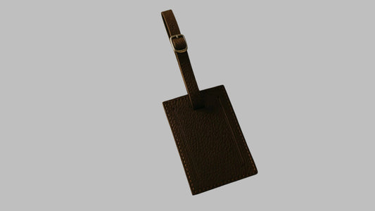 Brown leather luggage tag on a white background