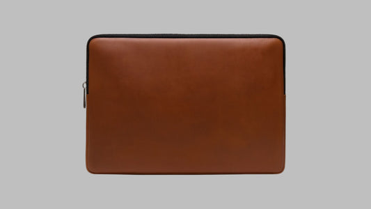 Brown leather laptop sleeve on a white background