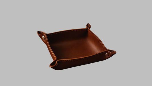 Brown leather tray with rounded corners on a white background